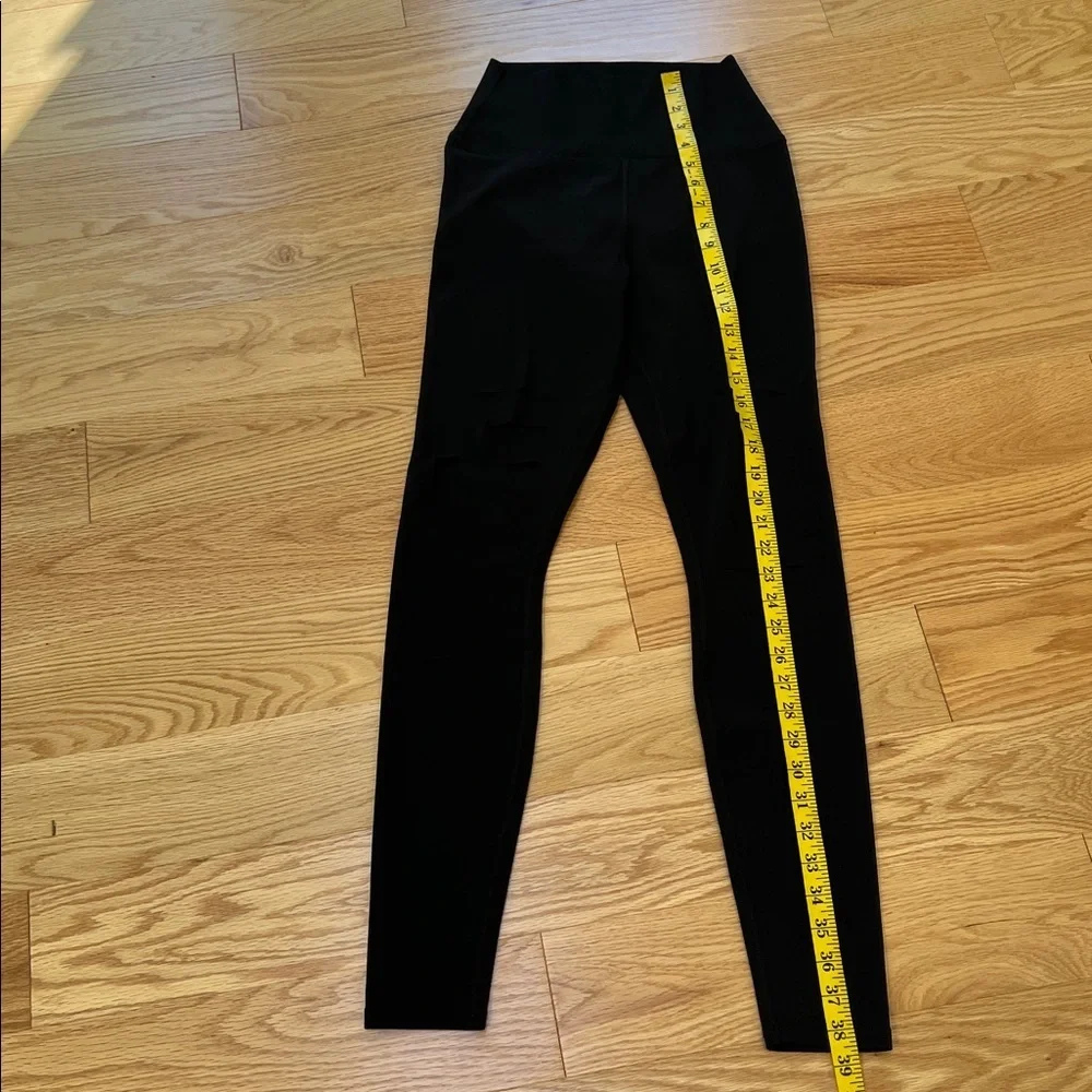 ALO Yoga black ripped high waist warrior leggings.